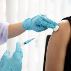 Person receiving a vaccine shot in the arm